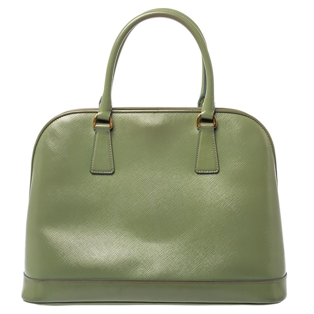Characterized by a unique dome shape, this satchel from the house of Prada is a chic way to carry your everyday essentials in style. Elegantly crafted from lush leather, this bag adds an exquisite touch to your casual attire and makes sure you