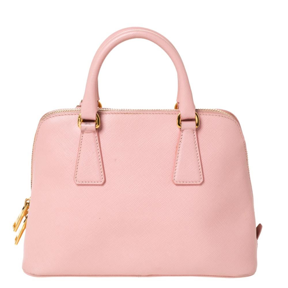 This stunning Promenade satchel is high on appeal and style. Dazzling in a pretty pink shade, the bag is crafted from leather and features two rolled handles. The zip closure leads way to a nylon interior with enough space for your essentials and