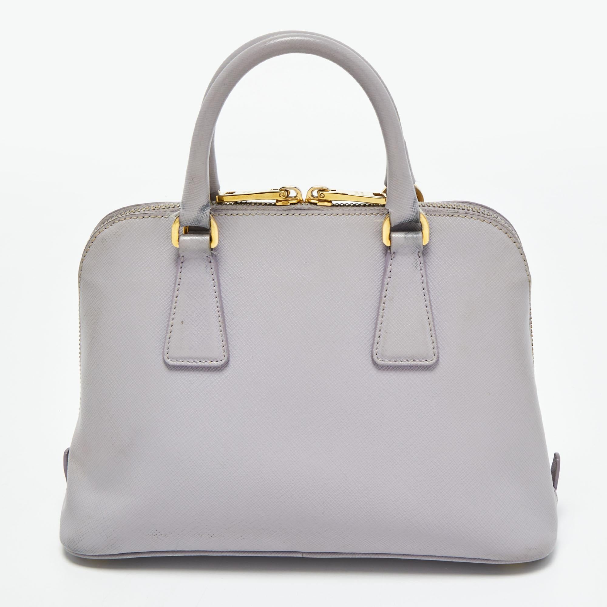 The simple silhouette and the use of durable materials for the exterior bring out the appeal of this Prada satchel for women. It features comfortable handles and a well-lined interior.

Includes: Detachable Strap
 