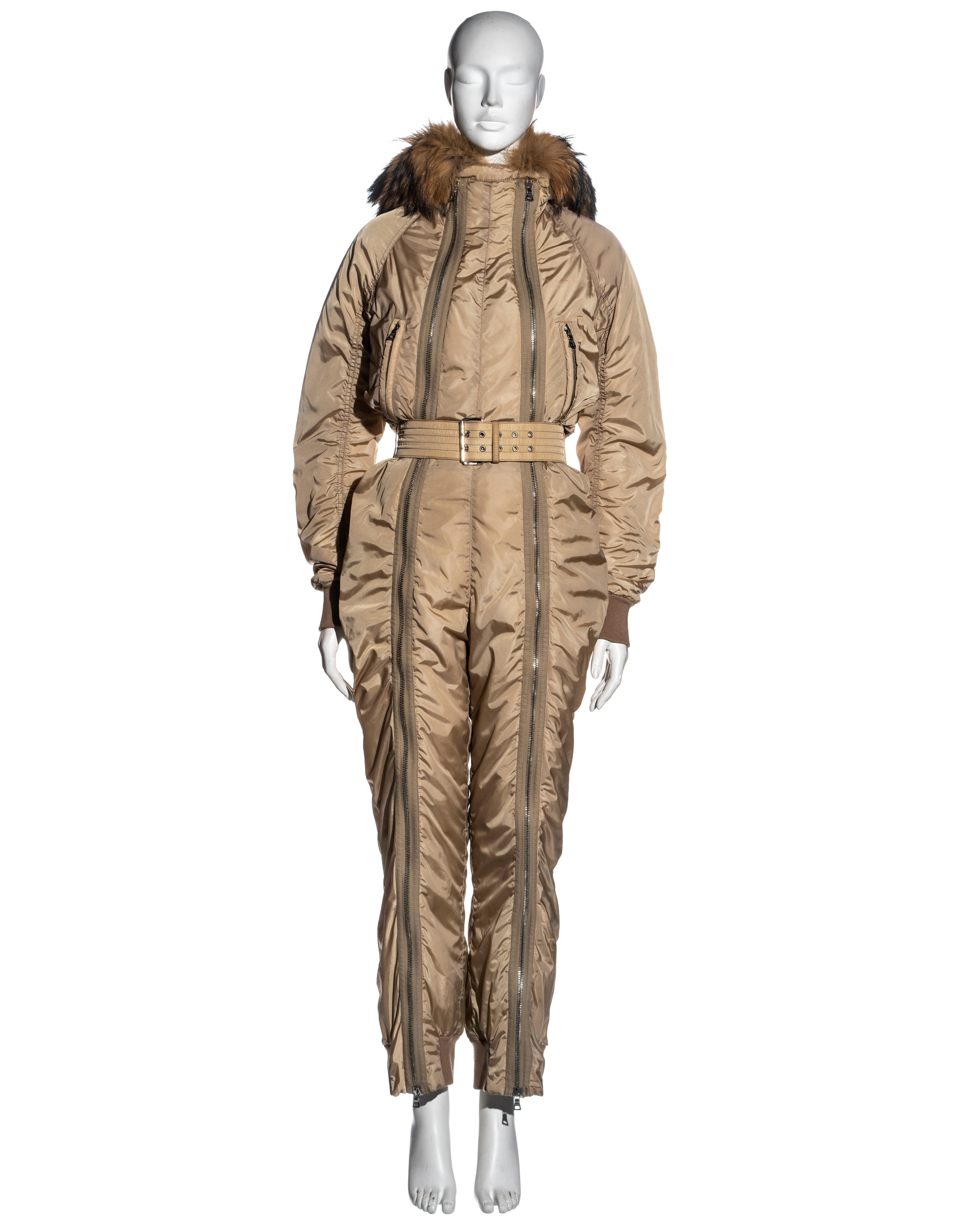 ▪ Prada Linea Rossa sand padded nylon ski suit
▪ Padded nylon
▪ Raccoon fur hood with shearling lining
▪ Two full-length double-ended zippers running from the neck to the ankles
▪ Matching belt
▪ Ribbed-wool cuffs and ankles
▪ Size 38
▪ Fall-Winter