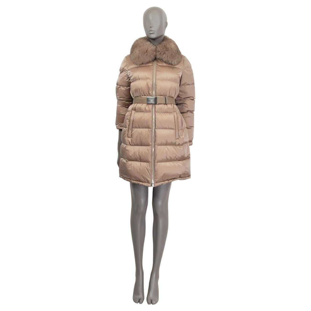 100% authentic Prada belted coat in light gray nylon (100%). Features two zip pockets on the front. Has a fur collar and buttoned cuffs. Opens with a silver metal zipper on the front and a button on the front. Unlined. Coated with down and