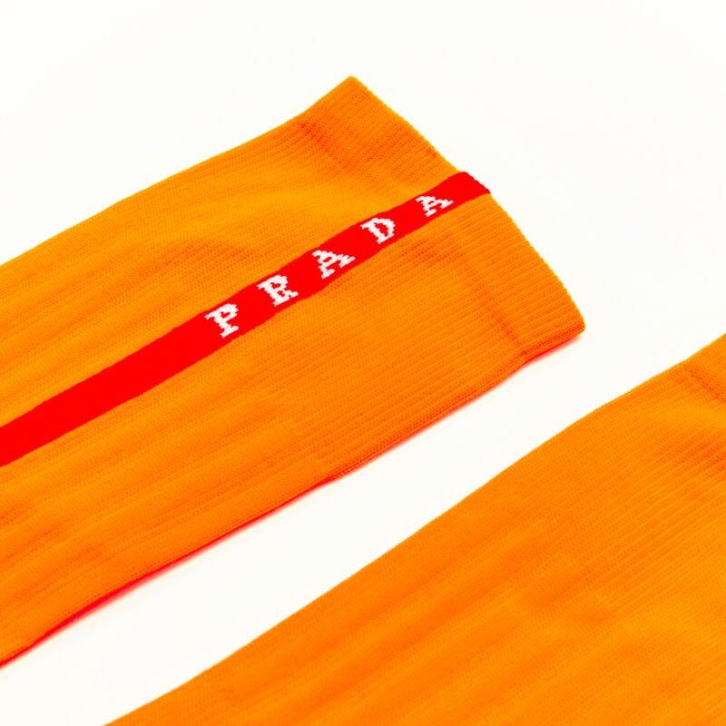 PRADA Linea Rossa neon orange red line logo cotton socks nylon pouch
Reference: ANWU/A00101
Brand: Prada
Designer: Miuccia Prada
Material: Cotton
Color: Orange
Pattern: Solid
Extra Details: Comes with Linea Rossa waterproof zip pouch