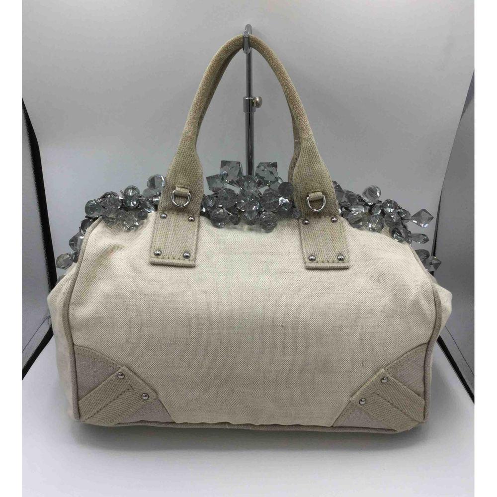 Prada Linen Handbag in Beige

Prada bag in beige linen with a row of transparent plastic crystals covering the closure. Height 22 cm, width 33 cm, bottom 18 cm and handle 15 cm The bag is in excellent condition, with dustbag and certificate of