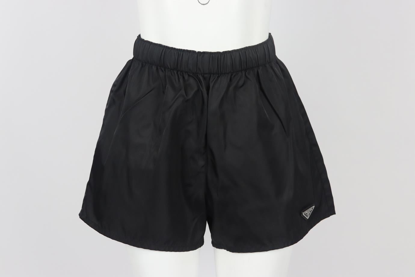 Prada logo appliquéd shell shorts. Black. Pull on. 100% polyamide. Size: IT 42 (UK 10, FR 38, US 6). Waist: 25.5 in. Hips: 41.8 in. Length: 15.7 in. Inseam: 3 in. Rise: 14 in. Very good condition - Some small marks; see pictures.