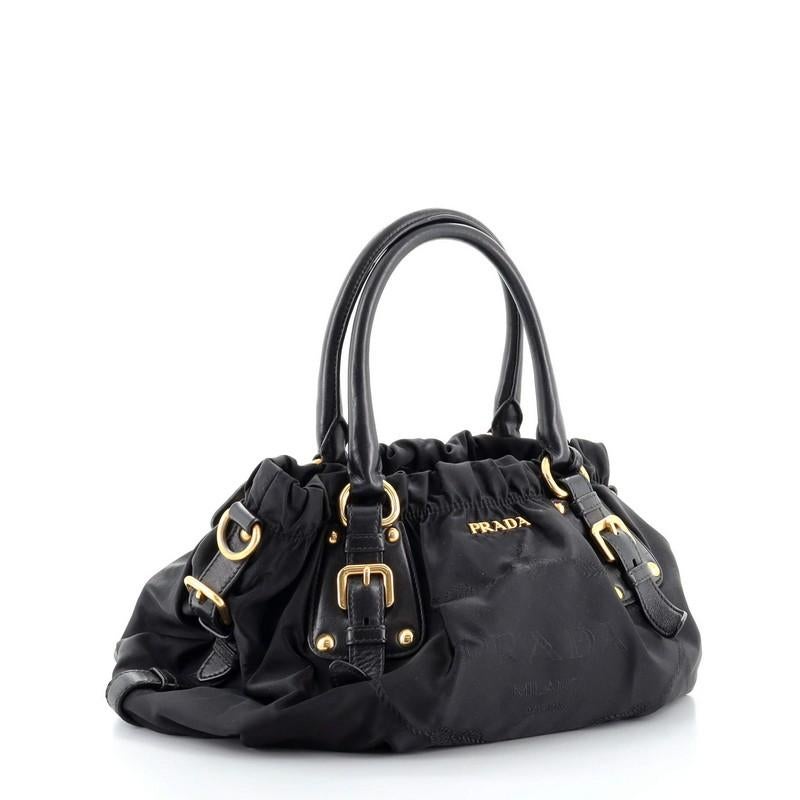 Condition: Good. Creasing and small marks on exterior, moderate wear and scuffs on leather trims, handles and strap, curling on belt trims. Cracking on handle base and belt trim trim wax edges, splitting and peeling on luggage tag wax edges,