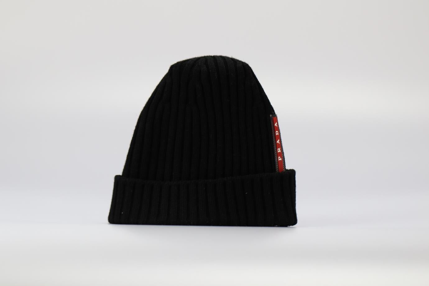 Prada Logo Detailed Ribbed Wool Beanie. Black. Pull on. Does not come with - dustbag or box. 100% Virgin wool. Medium. Circumference: 19 in. Condition: Used. Very good condition - No sign of wear; see pictures
