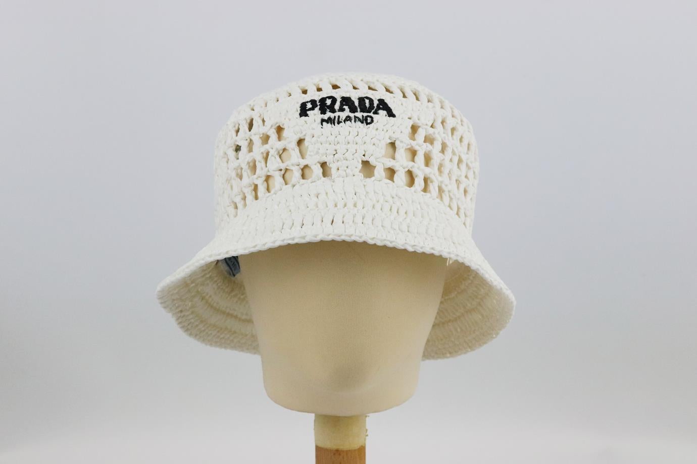 Prada logo embroidered raffia bucket hat. White and black. Slips on. Comes with dustbag. Size: Large (Circumference: 22.2 in)
