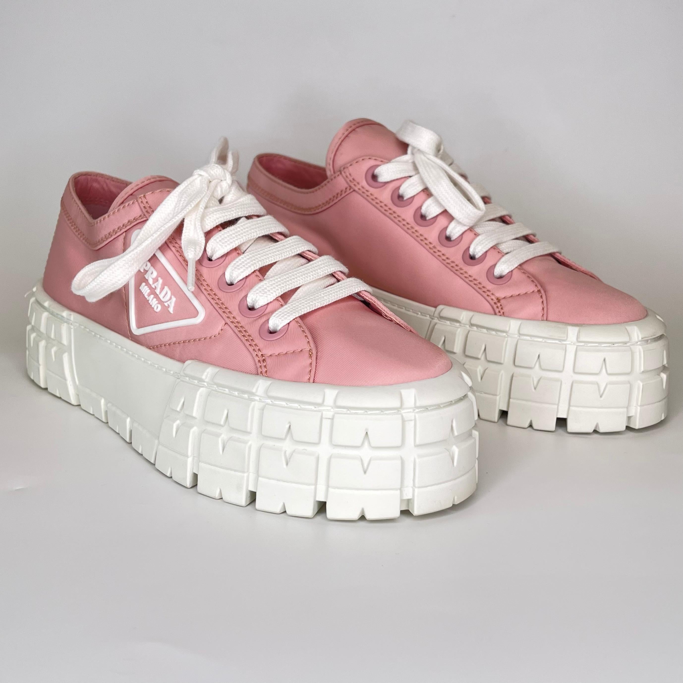 These sneakers featured Prada’s signature triangular logo on the side, a pink textile exterior, notched grooves that climb the large white platform and lace-up fastening.

COLOR: Pink / white
MATERIAL: Textile
SIZE: 7.5 US / 38.5 EU
PLATFORM HEIGHT: