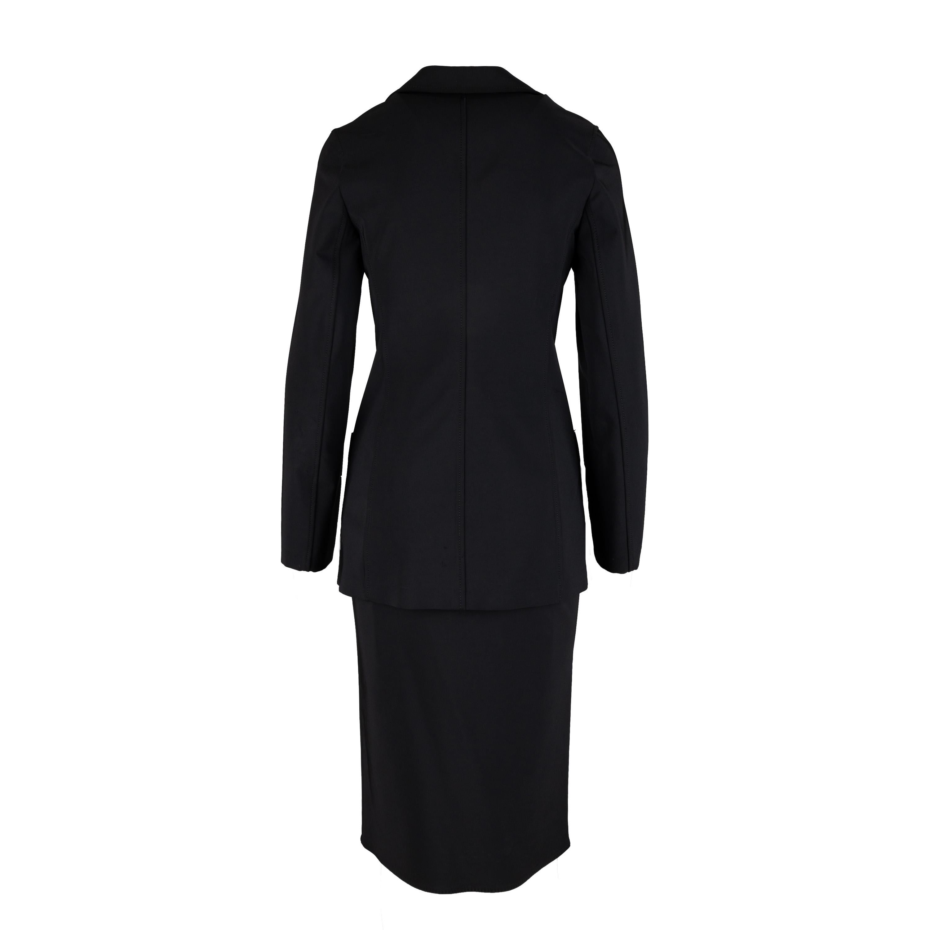 This Prada Long Jacket and Skirt Set is tailored to perfection with a structured fit. The long suit jacket has a collar and three front buttons, with two front pockets, while the skirt has a side zipper closure. Crafted from a stretchy fabric for