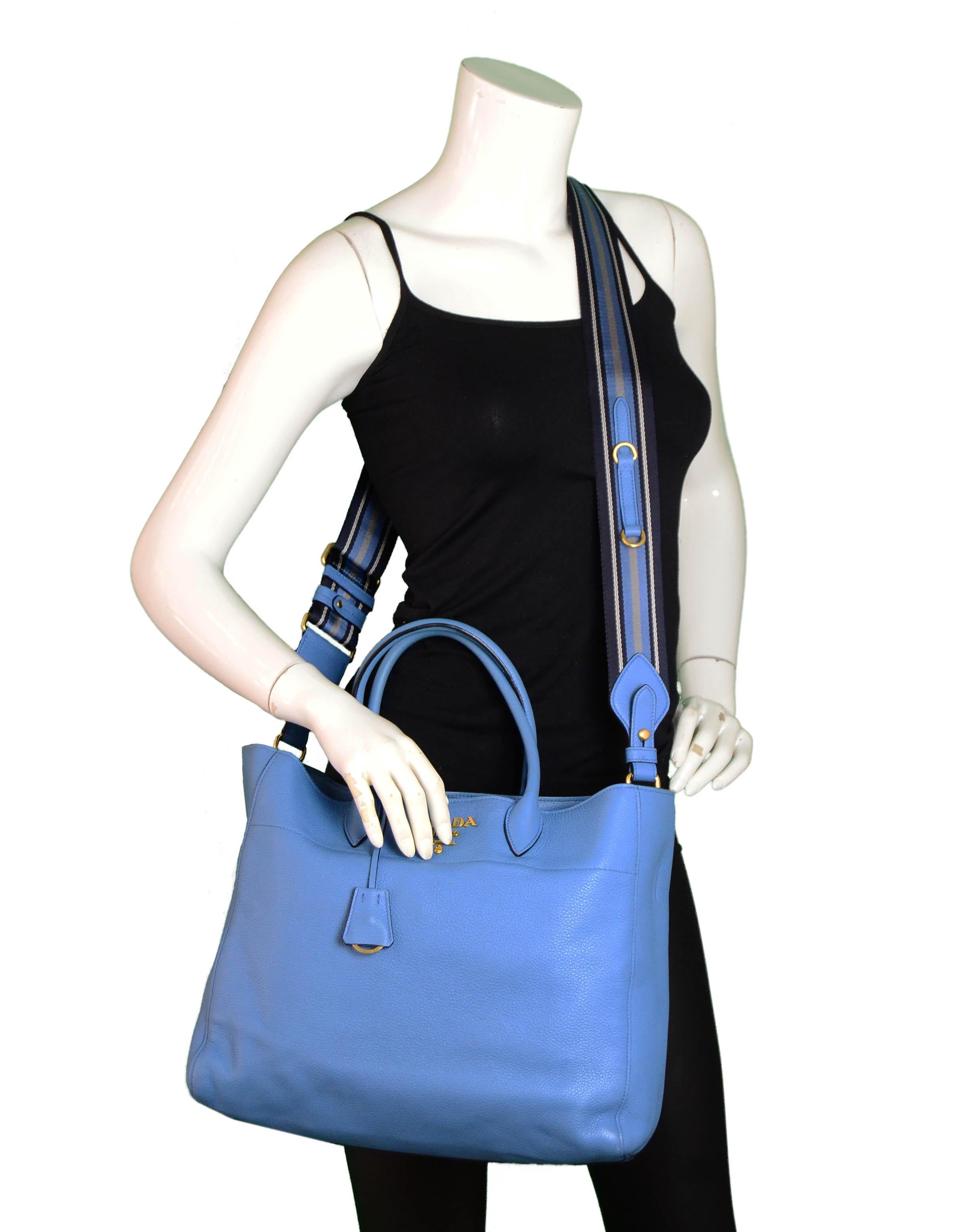 Prada Mare Blue Vitello Daino Leather Tote Bag.  Features detachable canvas strap.

Made In: Italy
Year of Production: 2018
Color: Mare blue
Hardware: Goldtone
Materials: Vitello Daino leather
Lining: Black textile
Closure/Opening: Magnetic
Interior