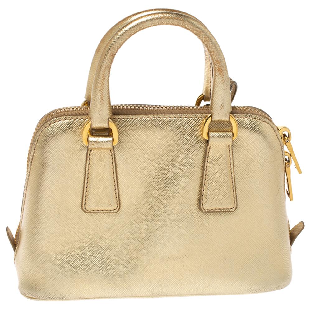 This stunning Promenade bag is high on appeal and style. Dazzling in a classy gold shade, the bag is crafted from leather and features two rolled handles. The zip closure leads way to a nylon interior with enough space for your essentials and the