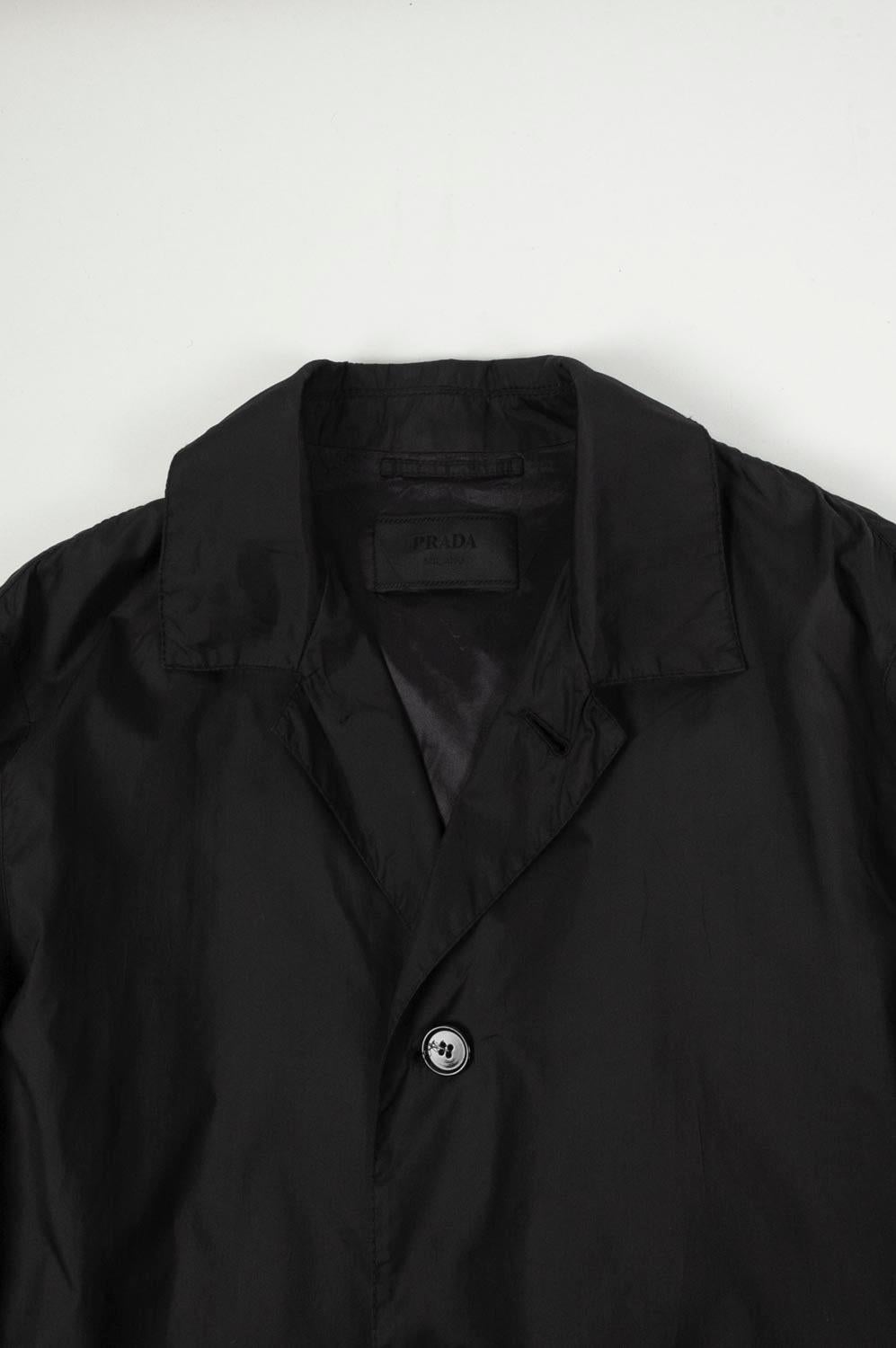 Item for sale is 100% genuine Prada Men Belted Trench Coat, S425
Color: Black
(An actual color may a bit vary due to individual computer screen interpretation)
Material: 100% polyamide
Tag size: 50IT 
This coat is great quality item. Rate 8.5 of 10,