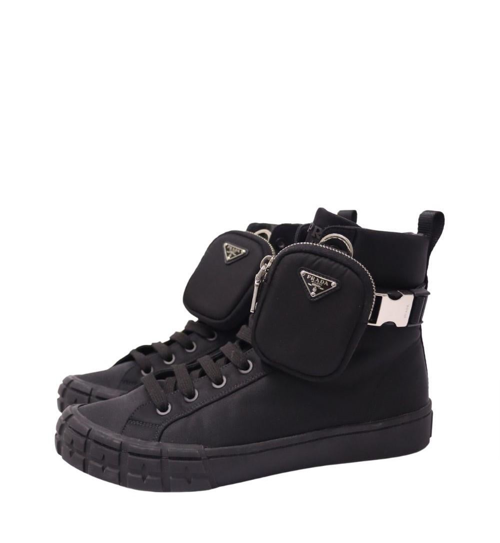 Prada Re-Nylon Wheel High-Top Sneakers, features a round-toe, lace up style, removable zipper pouch  and high top.

Material: 100% Regenerated Nylon
Size: EU 42.5 / US 8.5
Overall Condition: Excellent
Interior Condition: Like new
Exterior Condition: