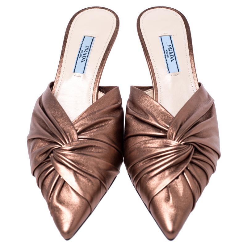 Comfort and fashion will always go hand in hand with these fabulous mules from Prada. These metallic bronze slip-on mules are crafted from leather and feature an open back design. They flaunt pointed toes, short heels and leather-lined