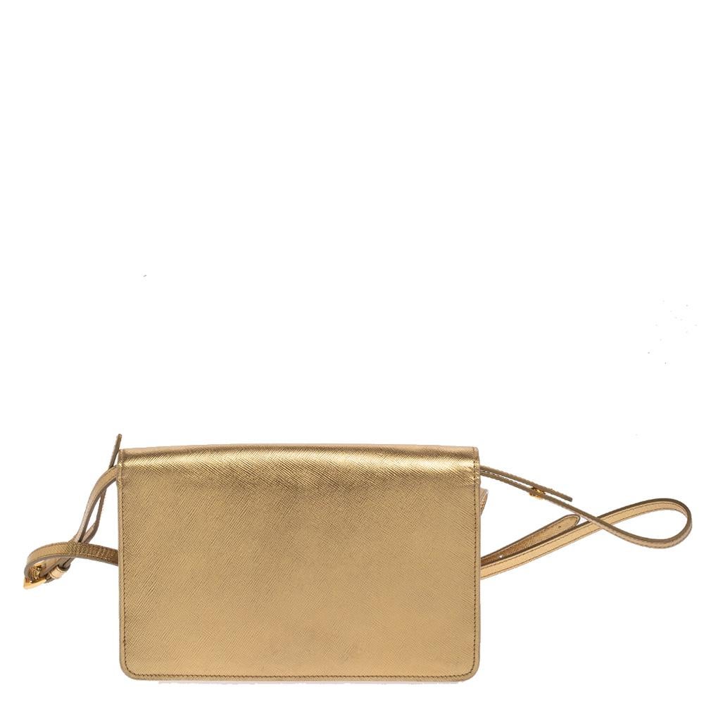 Incredibly stylish and statement-making, this crossbody bag from Prada is sure to be an amazing buy! The metallic gold creation is crafted from Saffiano leather and styled with a front flap that flaunts the brand logo. It is held by a thin shoulder