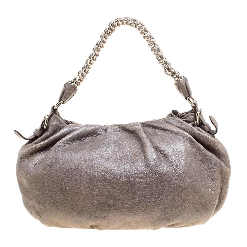 This Prada bag is perfect for almost all the occasions that you want an elegant accessory for. This skillfully designed leather hobo will perfectly complement your style and the nylon interior, as well as the chain handle, will assist you with