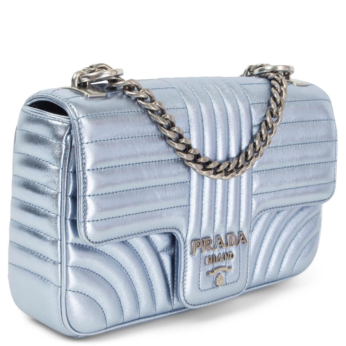 100% authentic Prada Diagramme Medium crossbody bag in quilted meatllic light blue smooth leather featuring silver-tone hardware. Comes with a sliding chain shoulder strap with shoulder pad. Opens with a magentic button under the flap and is lined