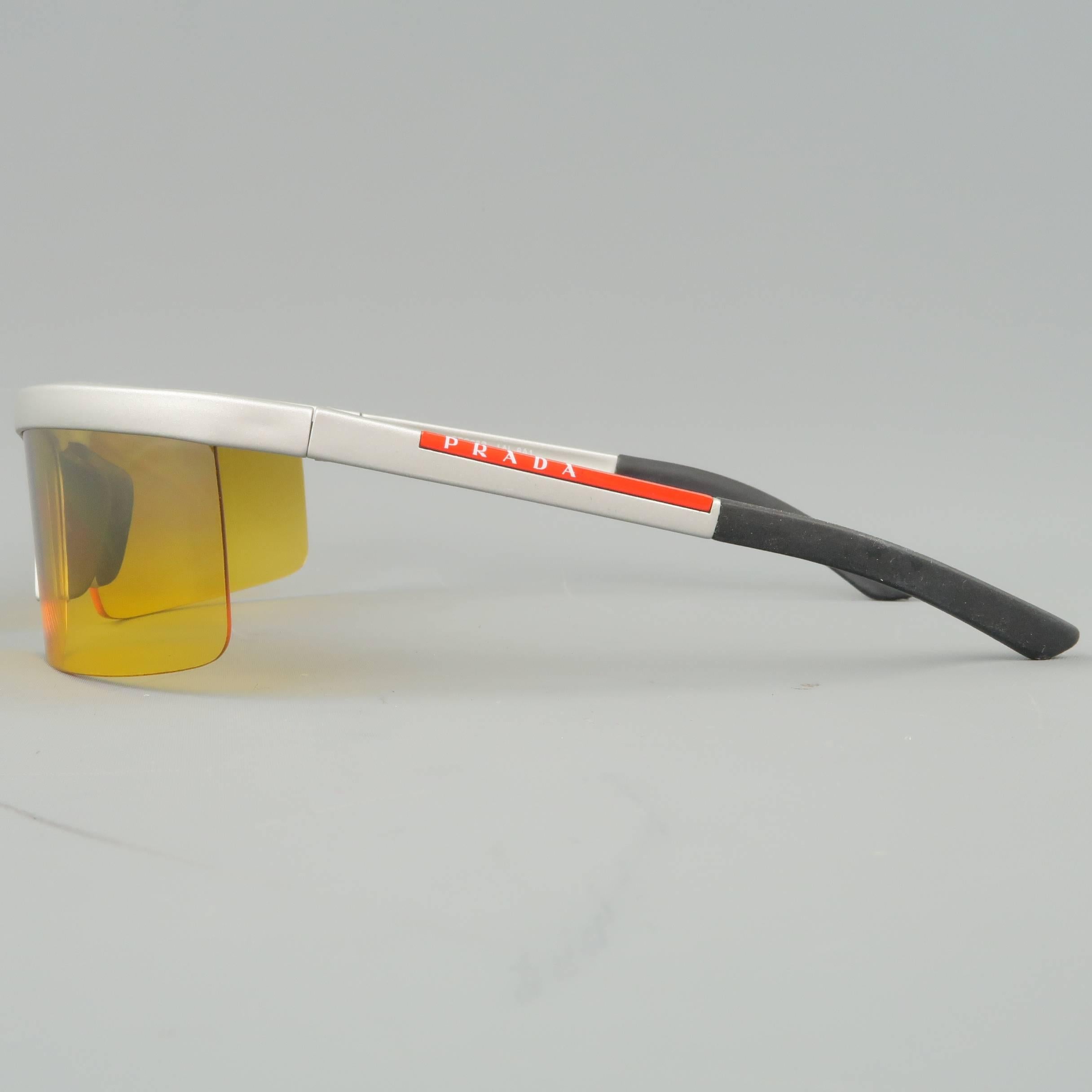 PRADA sport sunglasses come in a matte metallic silver acetate with red logo on arm and yellow square lenses. With case. Made in Italy.
 
Good Pre-Owned Condition.
Marked: SPS05B 1AL-8A1
 
Measurements:
 
Length: 14 cm.
Height: 4.10 cm