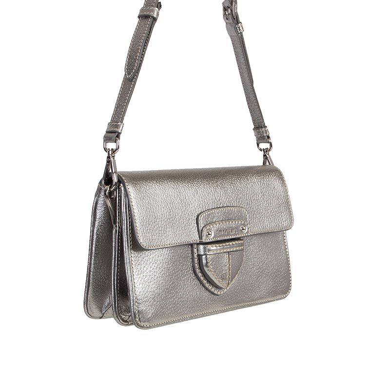 Prada crossbody in metallic sliver pigskin leather. Can also be carried as a clutch. Removable adjustable shoulder strap. Closes with a magnetic snap underneath the flap. Inside is divided in to two parts with an open pocket against the front and a