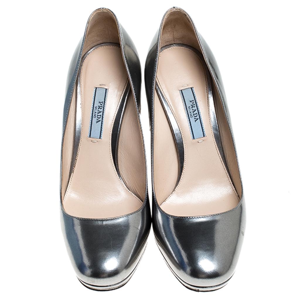 Fashionable and chic, these pumps from the house of Prada will cut an alluring silhouette from day to night. Crafted from silver foil leather with round toes, the pumps feature low platforms, high stiletto heels and comfortable insoles.

Includes: