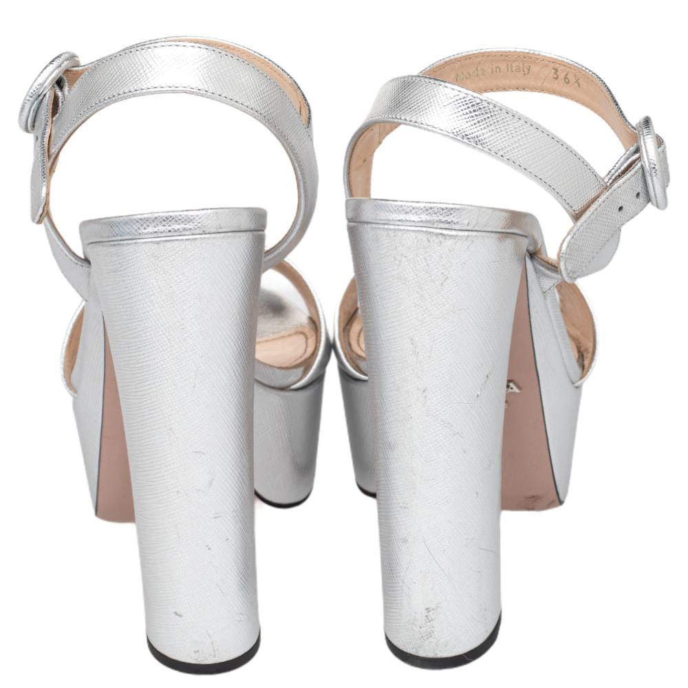 Nail a fashionable look in these Prada sandals. The open-toe platform sandals in metallic silver Saffiano leather have open toes, buckle fastening, and block heels.

Includes: Original Dustbag, Info Booklet, Original Box, Extra Dustbag