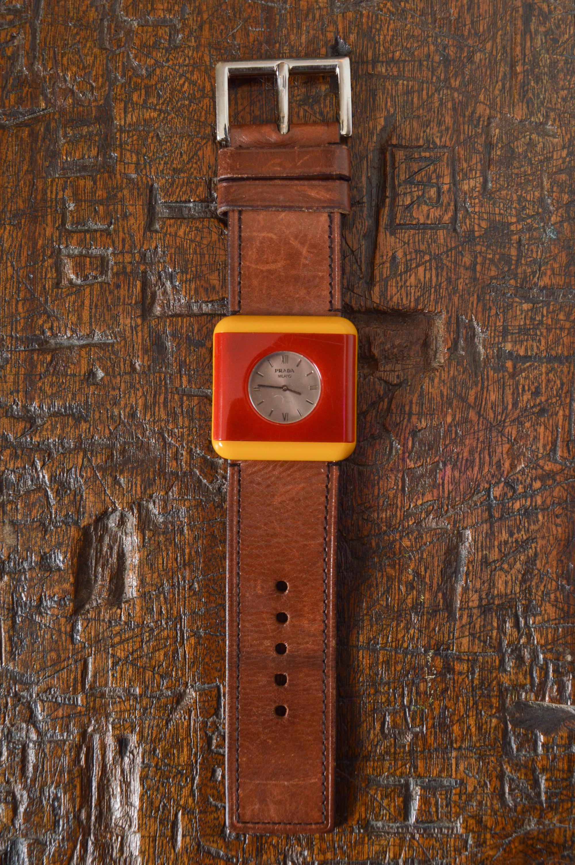 PRADA mid century Italian style Resin & Leather Cocktail Watch. 
Freshly Serviced Cocktail watch designed by Miuccia Prada for PRADA.
Resin Square shaped yellow and red entourage with circular clock face, Chrome buckle and Brown Leather Bracelet