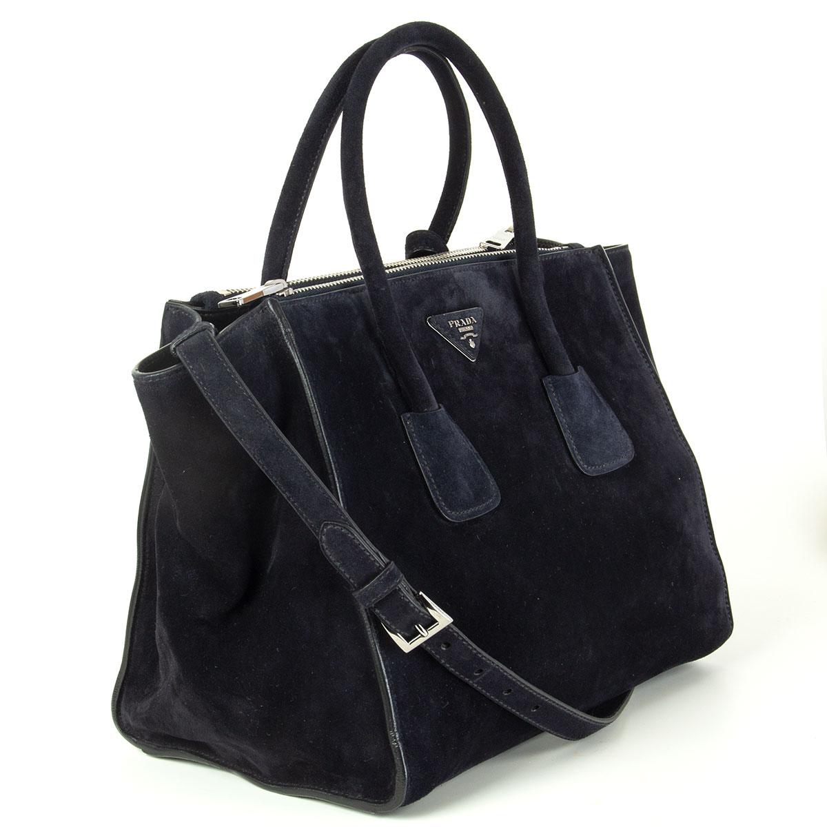 Prada 'Twin Pocket' tote in midnight blue Scamsciato suede featuring silver-tone hardware. Opens with a push-button and is lined in smooth black lambskin with two extra large zip pockets on the side, a small zip pocket against the back and a open