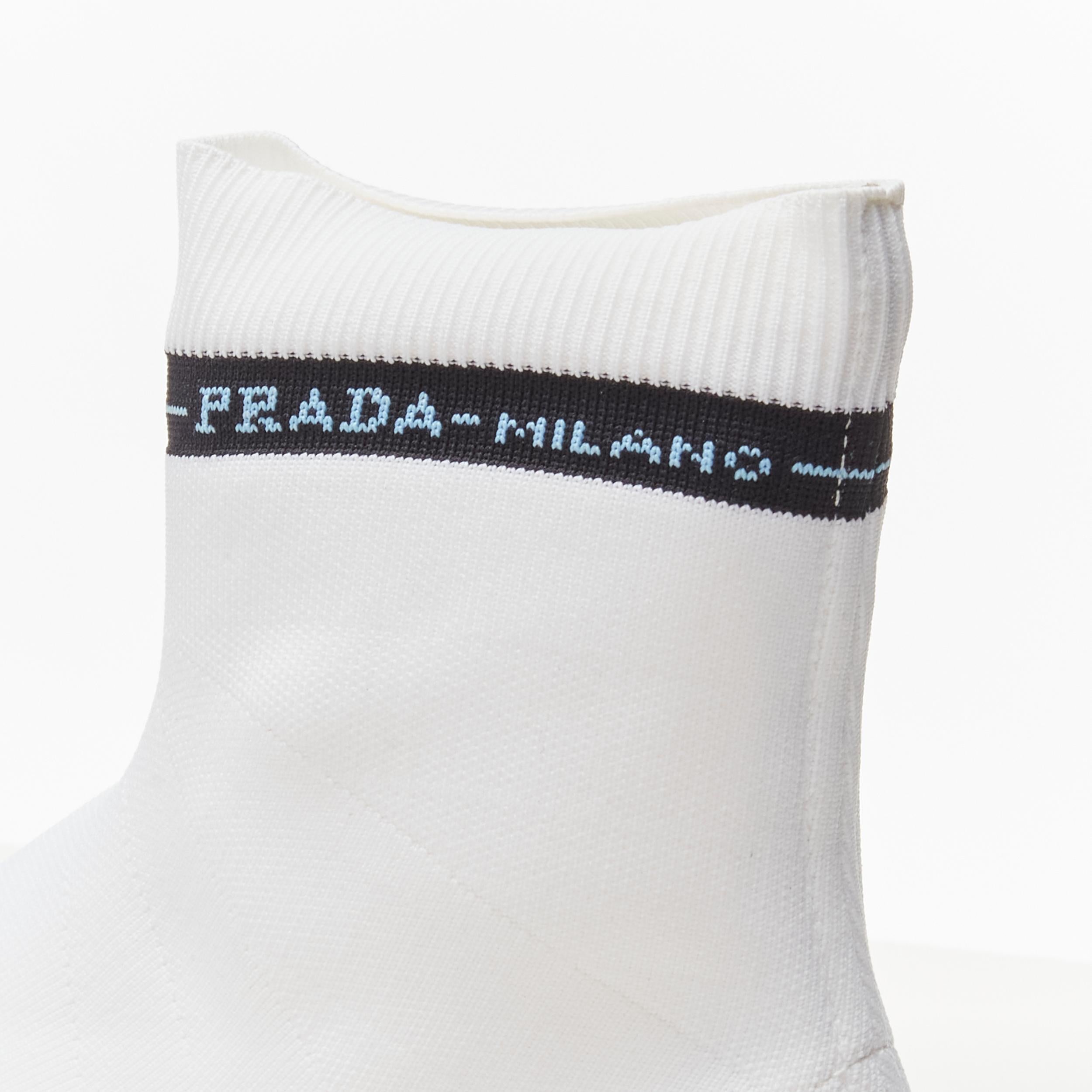 PRADA Milano black logo band white sock knit high top sneaker EU35.5 
Reference: ANWU/A00369 
Brand: Prada 
Designer: Miuccia Prada 
Material: Fabric 
Color: White 
Pattern: Solid 
Closure: Stretch 
Extra Detail: Black Prada Milano logo intarsia at