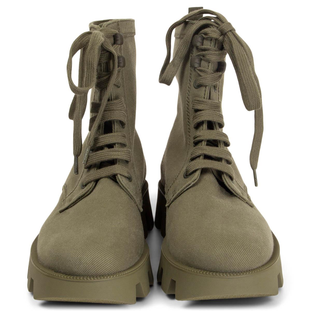100% authentic Prada Combat ankle boots in military green canvas with tonal laces, practical pull tabs and oversized, grooved rubber soles. Brand new. 

Measurements
Imprinted Size	38.5
Shoe Size	38.5
Inside Sole	26.5cm (10.3in)
Width	8cm