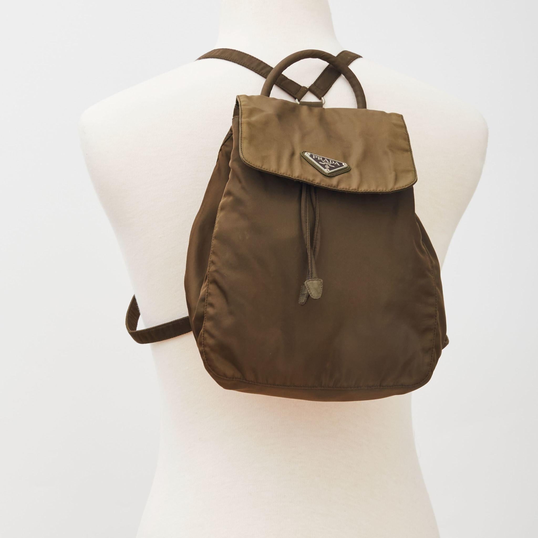 This vintage Prada city backpack is made of Tessuto nylon in Khaki or a military green. Prada reference No. B6631. I bought this bag in Pairs 1990s.

Code: 31
Comes with: Authenticity card
Condition: Very good. Lightly used bag.
Made in