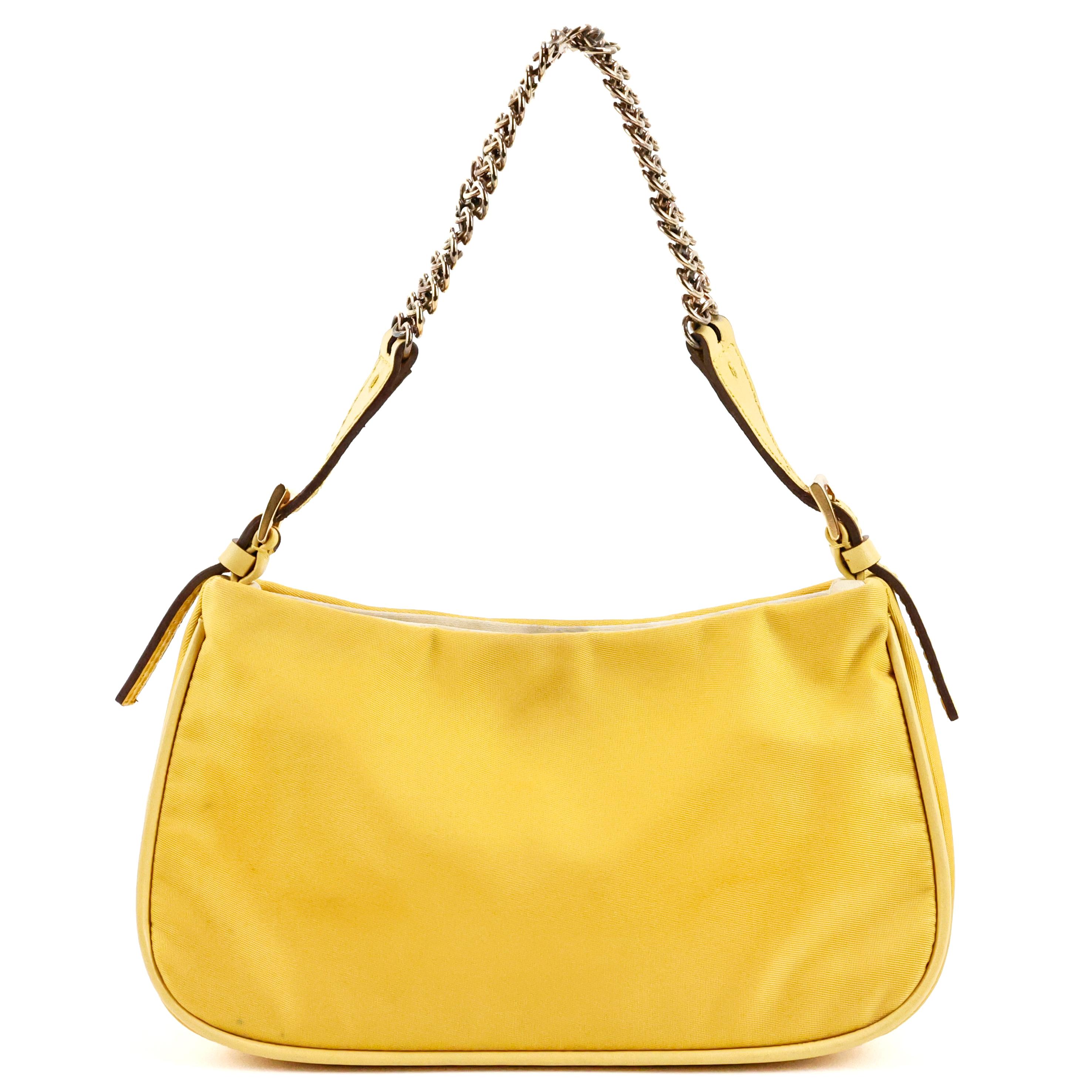 Prada mini Cleo bag in nylon color yellow, linning in silk color champagne, gold hardware. 

Condition:
Good. To note: some discolouration on chain, spot around on the magnetic closure.

Packing/accessories:
Dustbag.

Measurements:
18cm x 9,5cm x 6cm