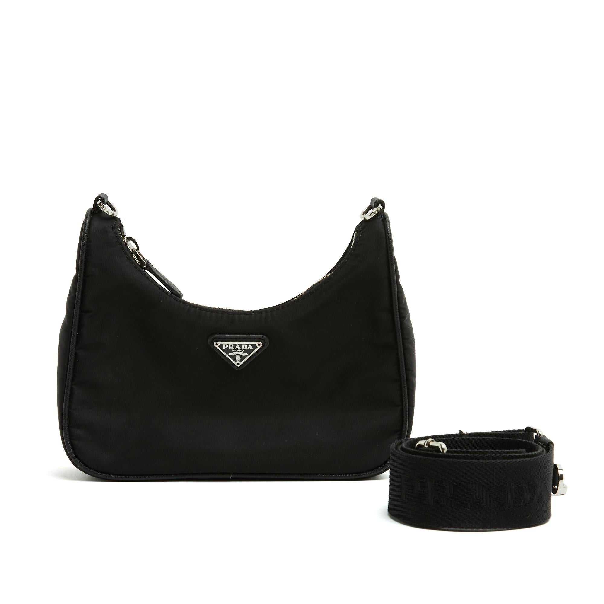 Prada Re edition 2005 mini bag in black Re-Nylon technical canvas and silver metal, Safiano leather details, interior in black Prada canvas, long removable and adjustable black cotton strap. Width 22 cm x height 12 to 18 cm (on the sides) x depth 7