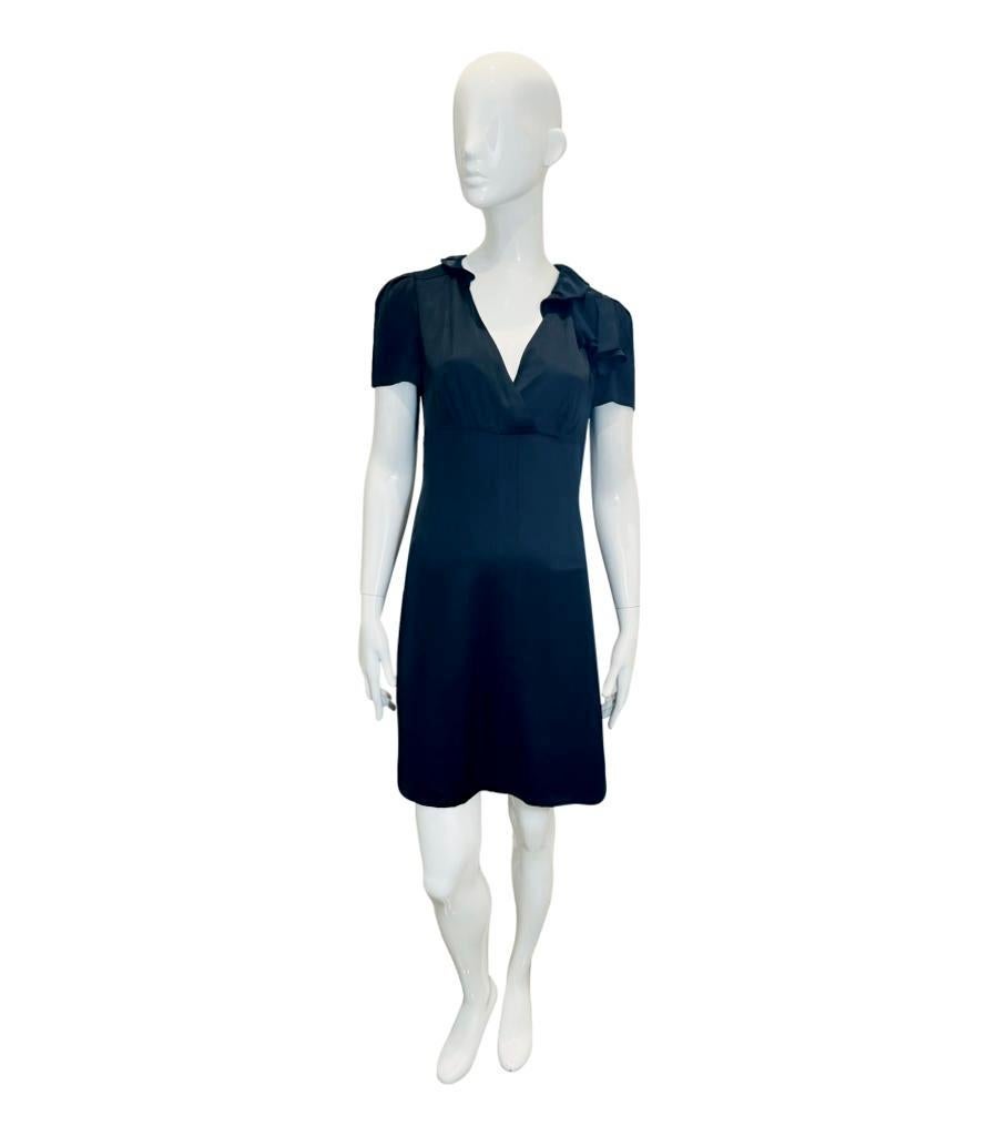 Prada Mini Silk Dress

Black dress designed with short sleeves and ruffle embellishment to one shoulder.

Featuring collared, wrap V-Neckline and flared skirt; zip closure to rear.

Size – 44IT

Condition – Very Good

Composition – 100% Silk