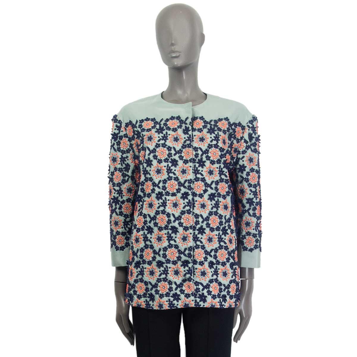 100% authentic Prada round-collar jacket in pale mint silk (46%) and cotton (45%) and polyester (9%) embellished with navy blue and coral flower embroidery. Jacket has two slit pockets on the side and and open with 5 hidden push-buttons to an