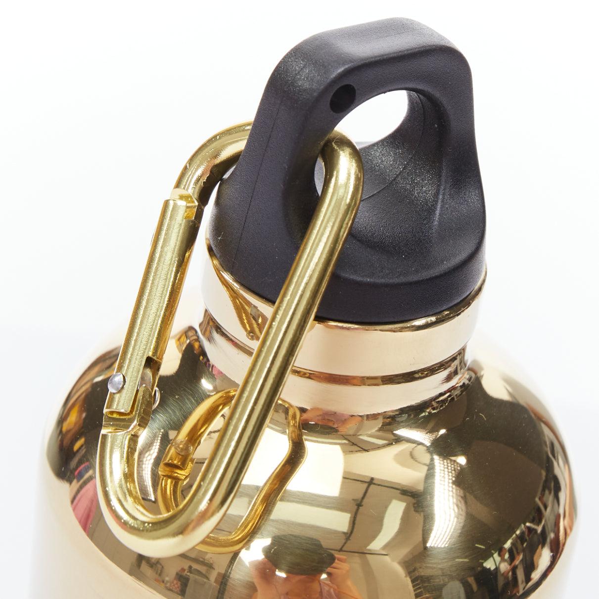 PRADA mirrored gold stainless steel black logo water bottle
Reference: TGAS/E00484
Brand: Prada
Designer: Miuccia Prada
Material: Metal
Color: Gold, Black
Pattern: Solid
Closure: Lobster Clasp
Extra Details: An essential for the modern woman