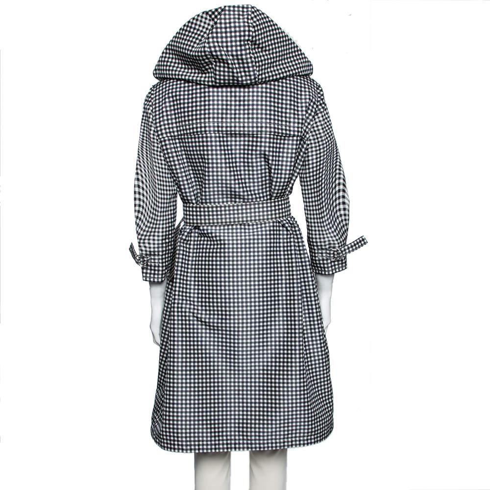 From the house of Prada comes another classic piece that is suitable for both formal and informal events. This monochrome checkered coat has been crafted from silk and displays a front zip closure and a belt that accentuates the flattering