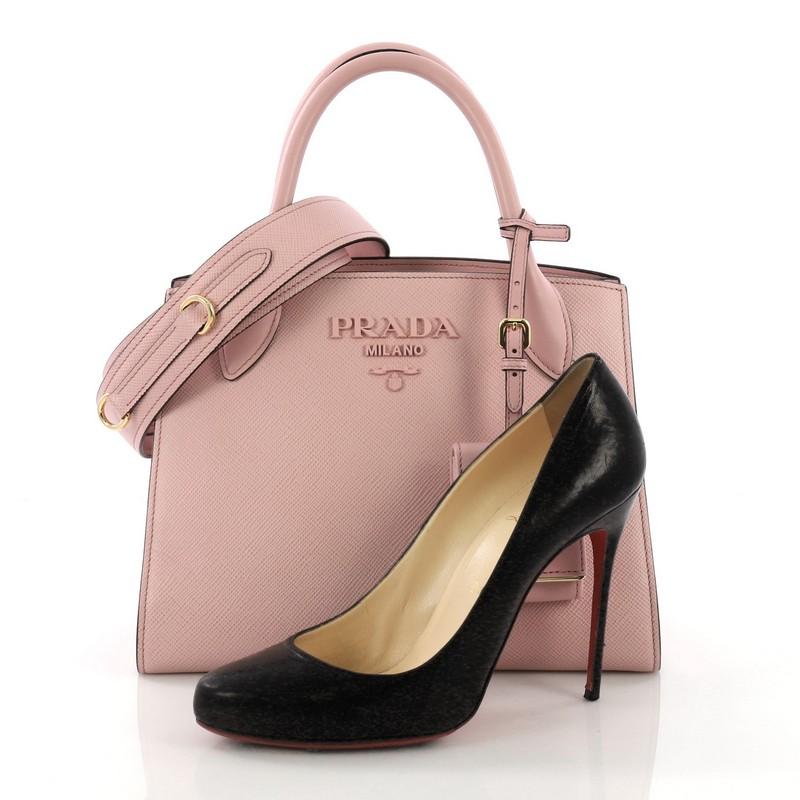 This Prada Monochrome Tote Saffiano Leather with City Calfskin Small, crafted in pink saffiano leather with pink city calfskin, features dual rolled leather handles, side snap buttons, and gold-tone hardware. It opens to a pink leather and fabric