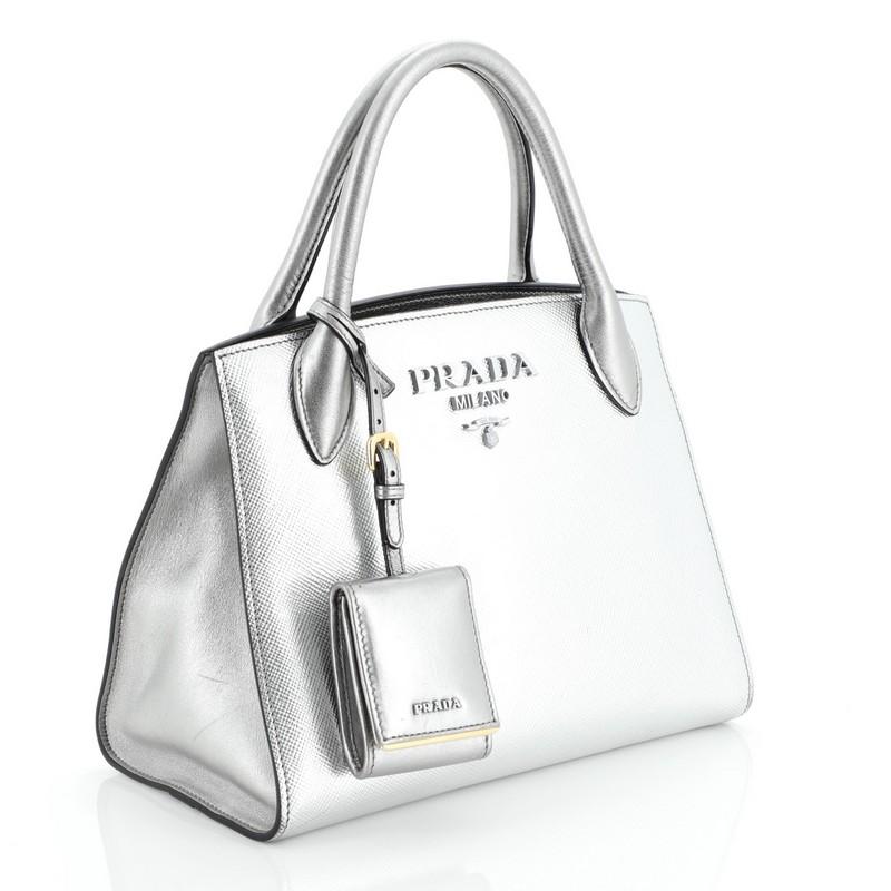 This Prada Monochrome Tote Saffiano Leather with City Calfskin Small, crafted from metallic silver saffiano leather with city calfskin, features dual rolled leather handles, Prada logo on front, and gold-tone hardware. It opens to a black fabric