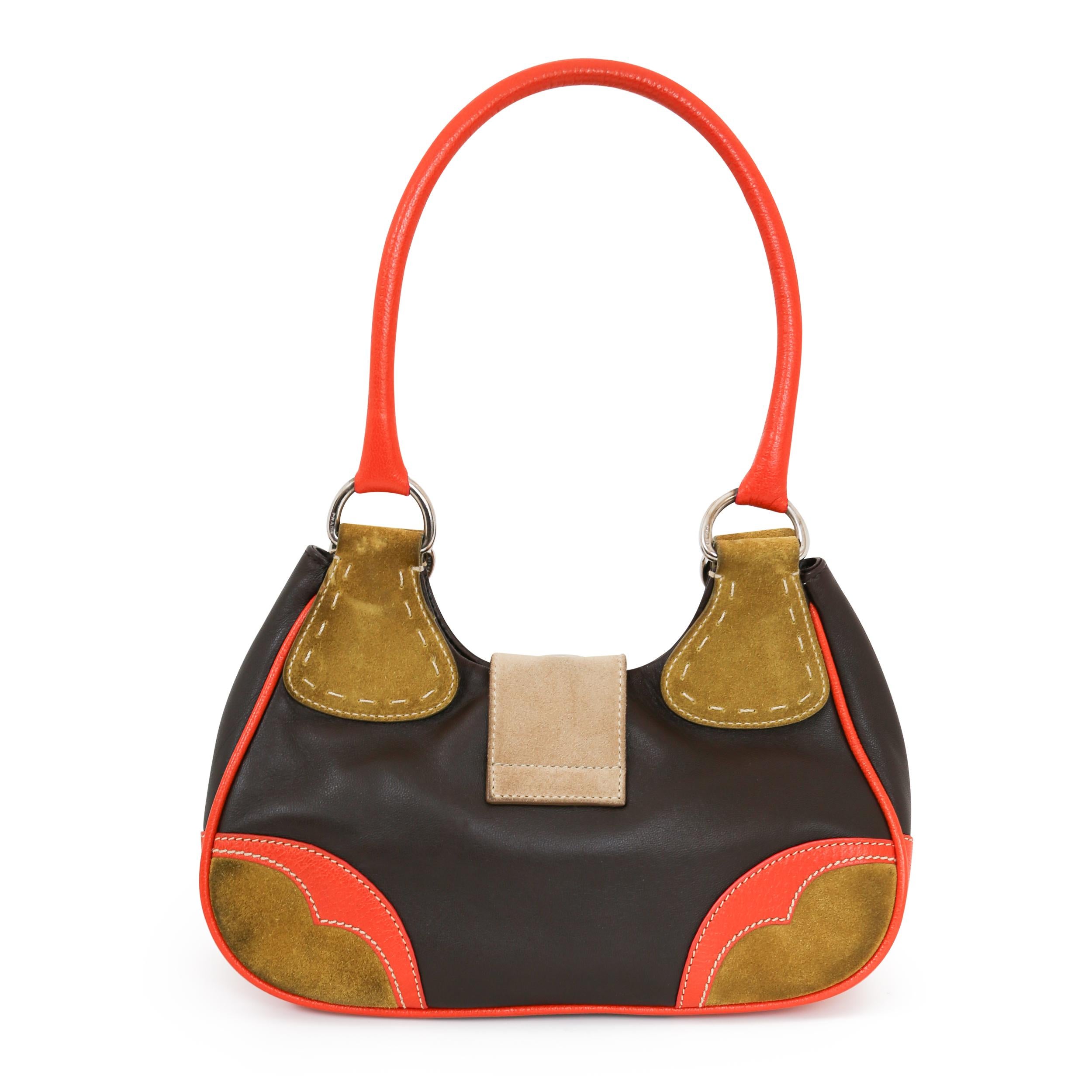 Die Moon Suede Handbag ist ein Vintage-Stück aus den 00er Jahren. Mit einer großen Magnetschnalle auf der Vorderseite ist diese Prada Tasche sowohl stilvoll als auch einfach zu bedienen. Die Innentasche mit Reißverschluss macht das ohnehin schon