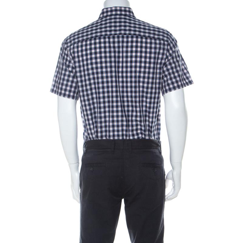 For days of style, Prada brings you this well-made creation. The cotton blend shirt, styled with a collar, short sleeves and check patterns all over, is both comfortable and stylish. It is a creation to aide your formal fashion.

Includes: The