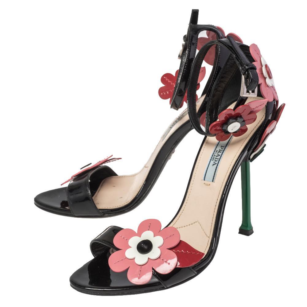 Prada brings a dreamy garden element to a pair of sandals by using flowers that will never stop blooming. The Prada sandals are sewn using leather into an open-toe silhouette, complemented by floral appliqués, ankle closure and high heels,

