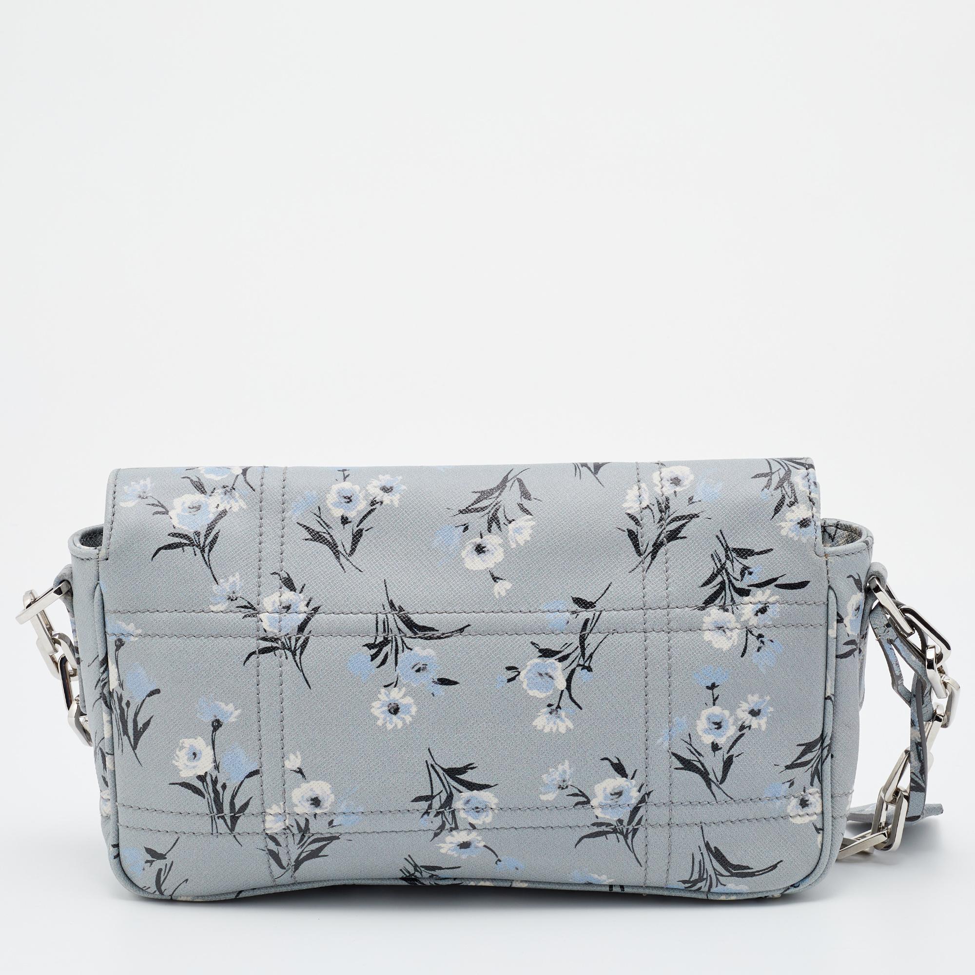 A beautiful designer piece is this shoulder bag to carry your essentials this season. Designed by Prada, the multicolored bag is made from Saffiano leather with silver-tone hardware. It features a spacious interior and lovely floral print all
