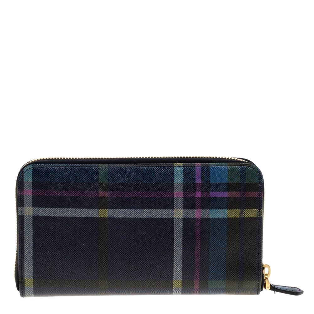 Try this amazing Prada wallet and organize some of the mess inside your bag. This wallet is crafted from plaid printed leather and has a zip closure that opens to an interior with multiple card slots and a zip pocket. The wallet is complete with the