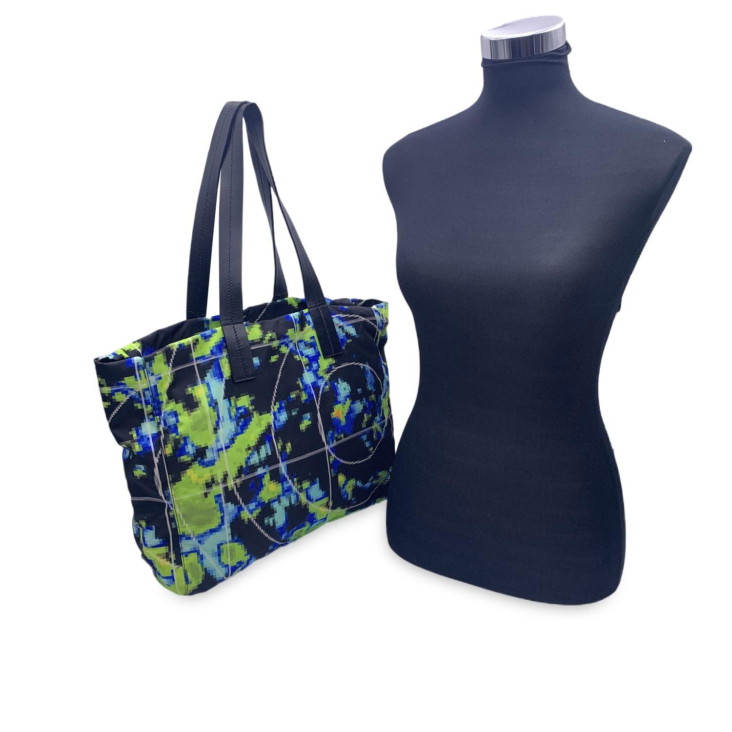 PRADA Tessuto Nylon Radar tote bag, crafted of Tessuto nylon with a radar print. from the Spring/Summer 2017 collection. The bag features 2 leather shoulder straps, an open top, side triangle logo, an open top, black nylon lining and 2 side zip