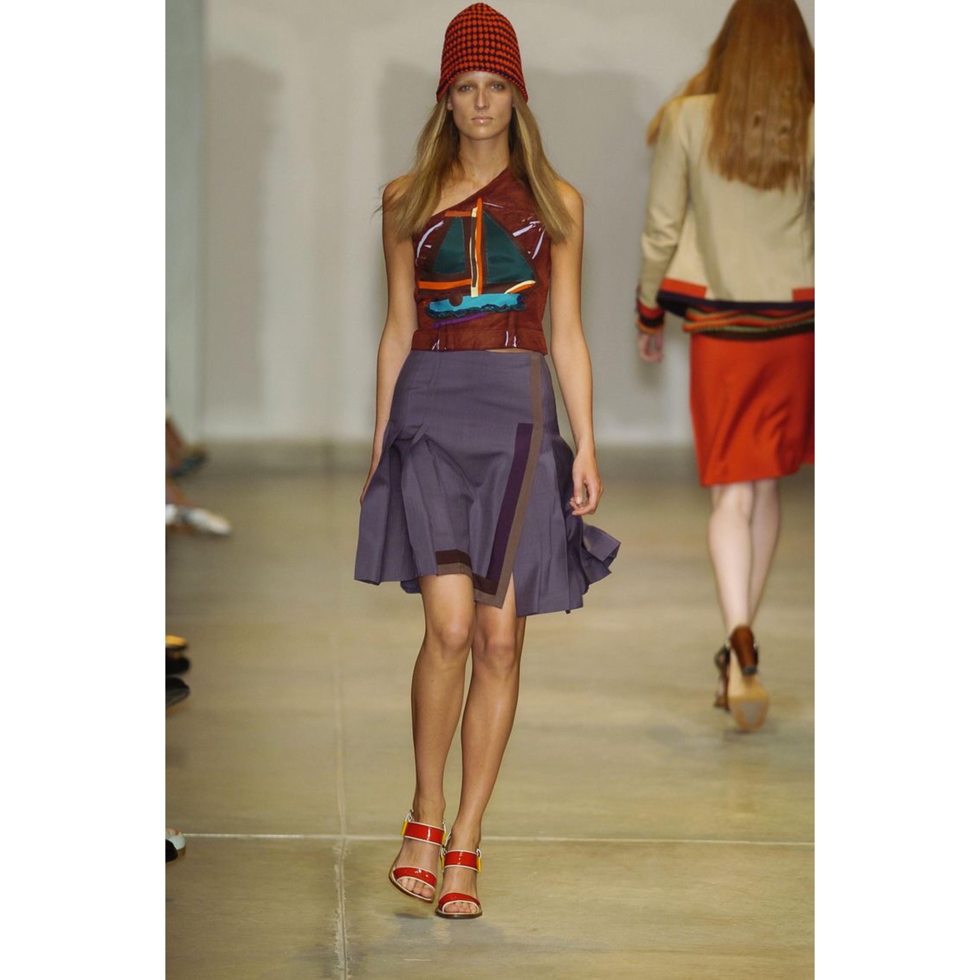 Inspired by the allure of the islands and a Caribbean charm, the Spring 2005 Prada collection showcased rich colors mixed with natural tones and textures. This top mixed with an arts-and-crafts aesthetic allowed for the collection to give off a more