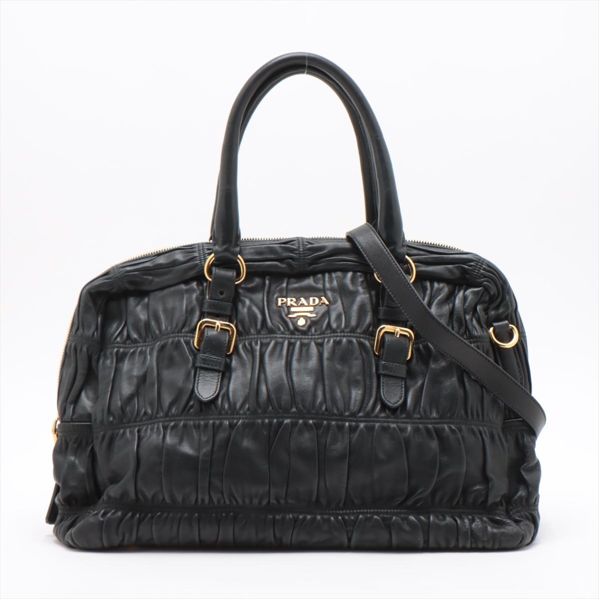 The Prada Nappa Gaufre Leather Two-Way Satchel Bag in Black is a luxurious and versatile accessory that seamlessly combines sophistication with practicality. Crafted from sumptuous Nappa Gaufre leather, the bag features a distinctive quilted pattern