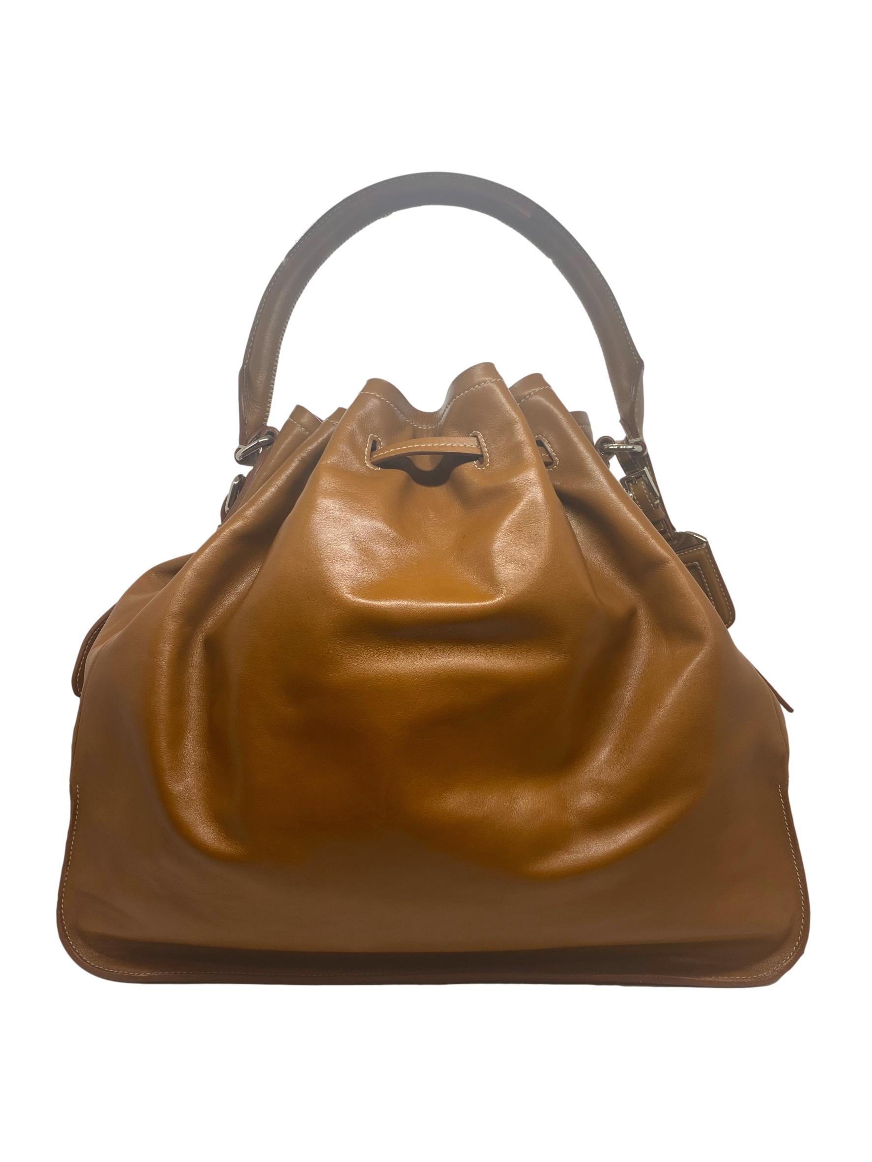 Prada Nappa Leather Drawstring Shoulder Top Handle Handbag, 2010. Founded by Mario Prada in 1913, Prada's flagship location opened in the Galleria Vittorio Emanuele II in Milan, the world's oldest shopping mall. By 1919, Prada officially became the