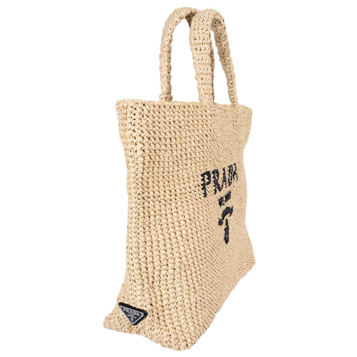 100% authentic Prada Logo crochet large tote bag with a soft, deconstructed design is made of raffia-effect yarn. The design features embroidered iconic lettering logo on the front and enameled metal triangle logo on the side. Unlined. Brand new.