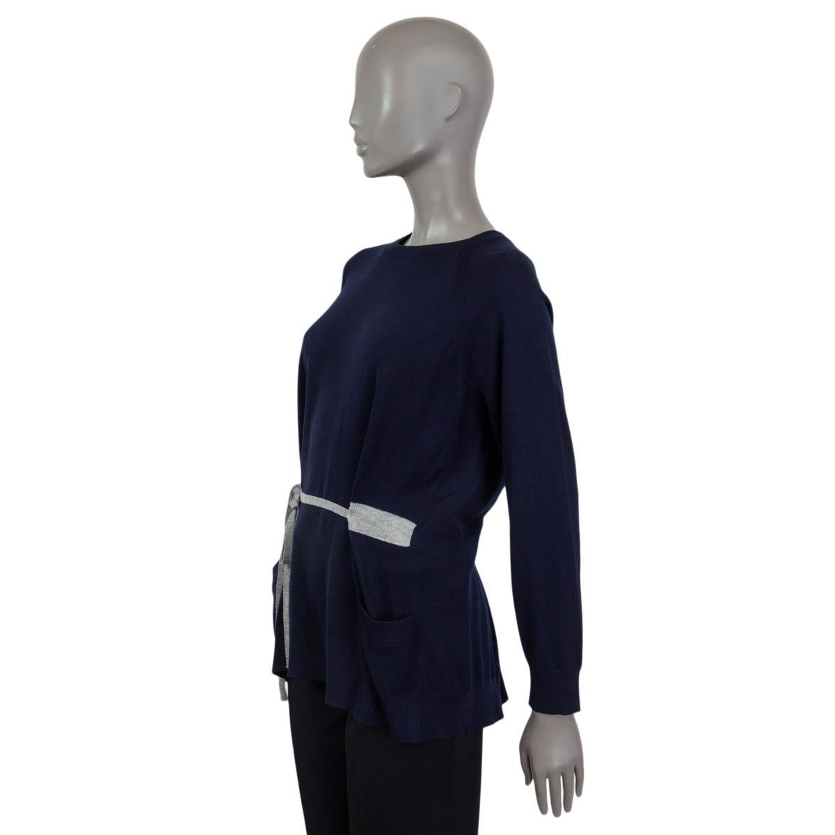 100% authentic Prada oversized raglan sleeve knit sweater in navy blue virgin wool with grey drawstring detail, two patch pockets at front and a buttoned back. Has been worn and is in excellent condition. 

Measurements
Tag Size	42
Size	M
Shoulder