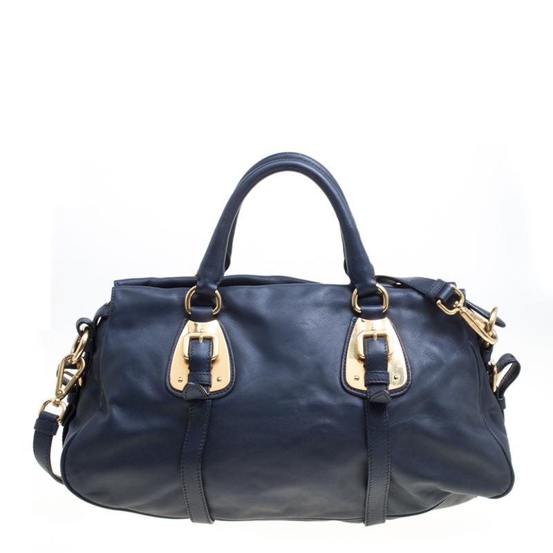 Sophisticated and luxe, this bag from Prada definitely needs to be on your wishlist. The satchel is crafted from leather in a lovely navy blue shade and it features an elegant design. It flaunts two handles and a zipper leading way to a spacious
